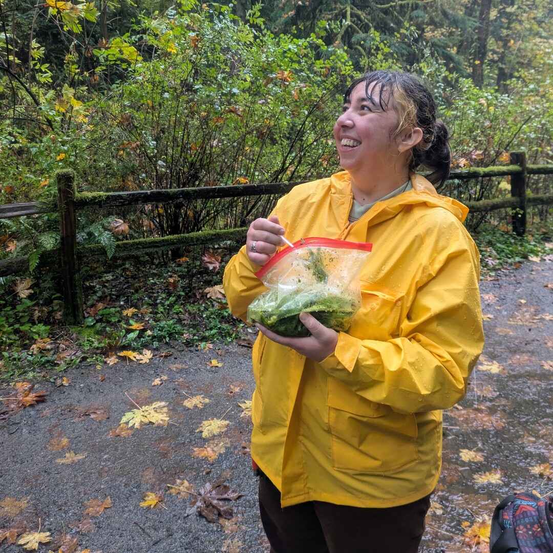 Clover Gardener, age 28, eating salad out of the bag in the woods.